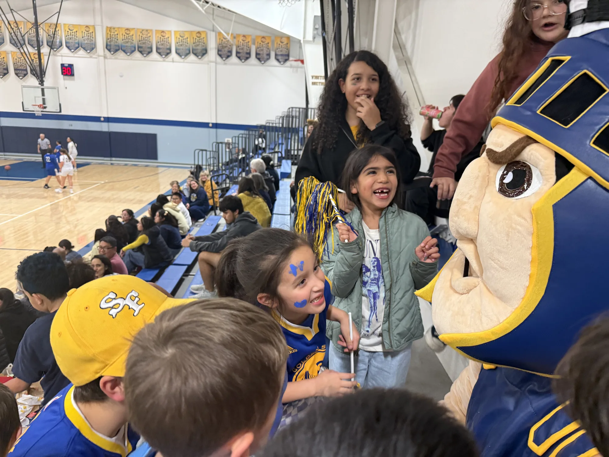 The Trojan mascot delighting young fans in the stands