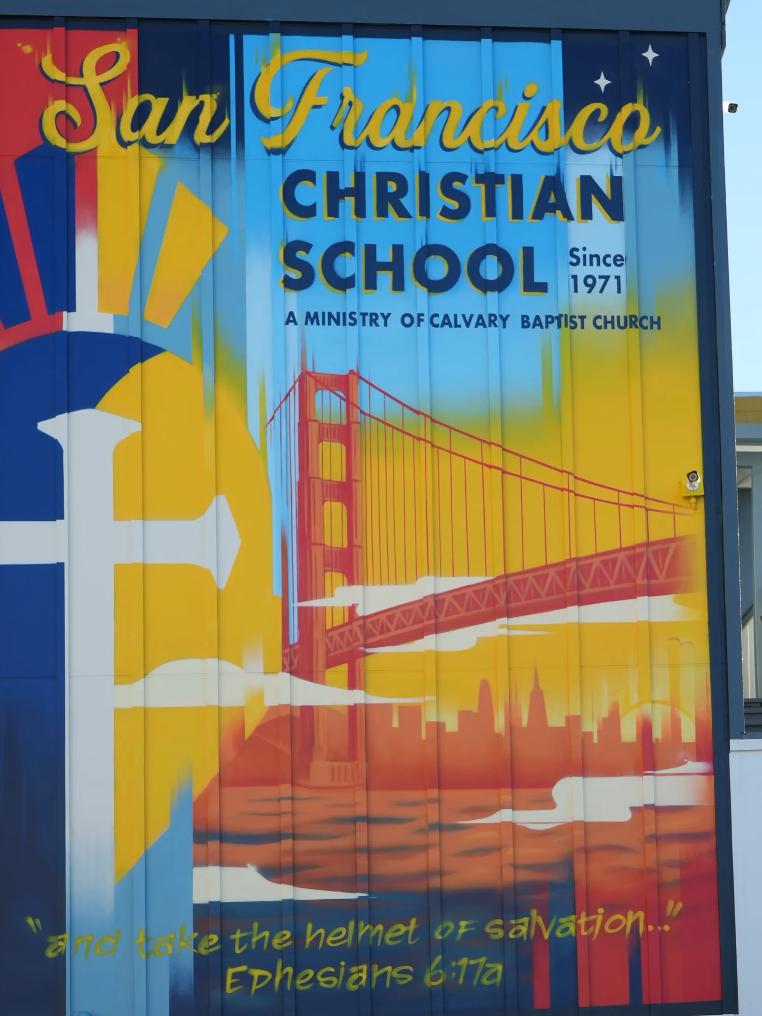 The school mural with the Golden Gate Bridge, the Trojan helmet, and the helmet-of-salvation verse from Ephesians 6:17