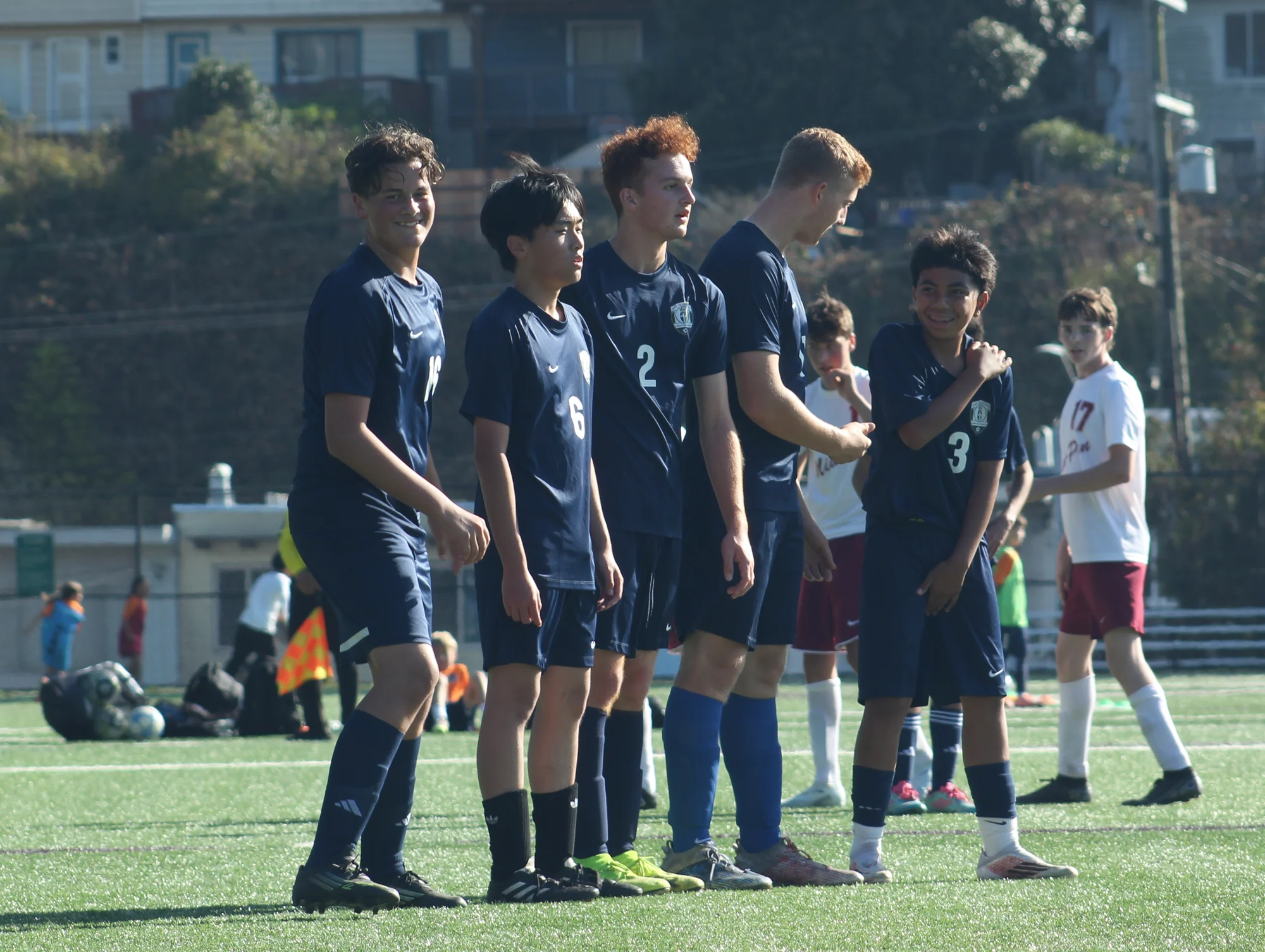 Trojans soccer players standing shoulder to shoulder in a defensive wall