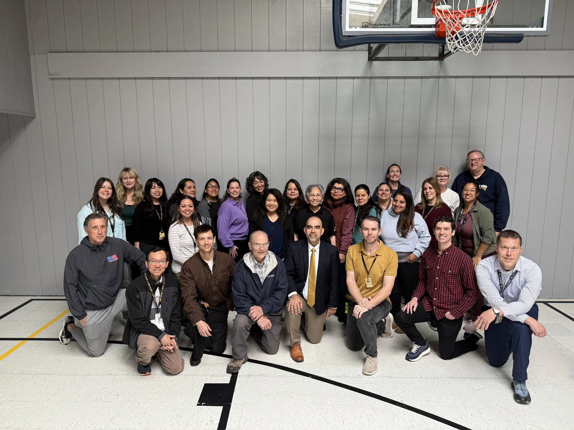 The full staff posed together in the gym