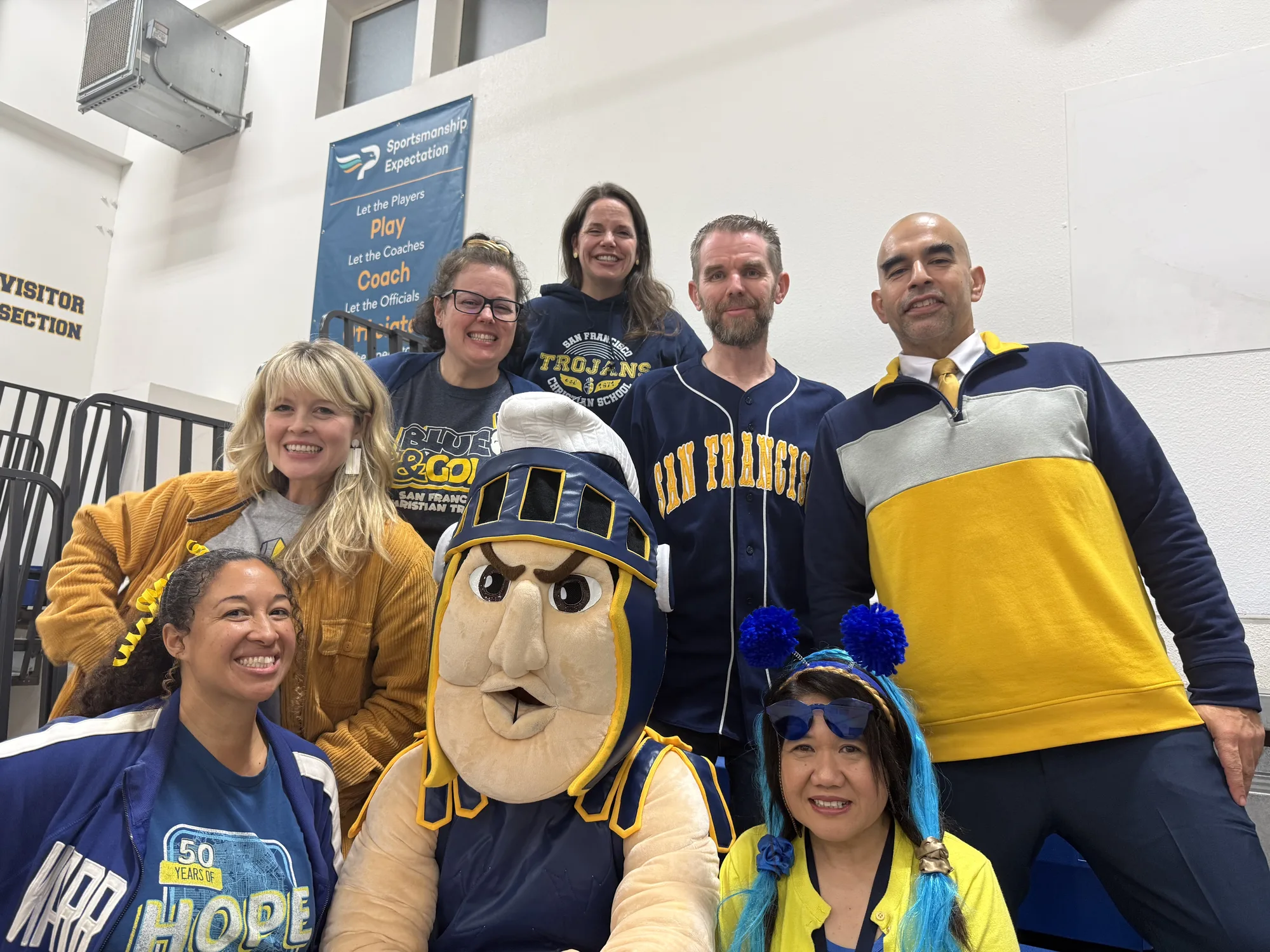 Staff members having fun with the Trojan mascot