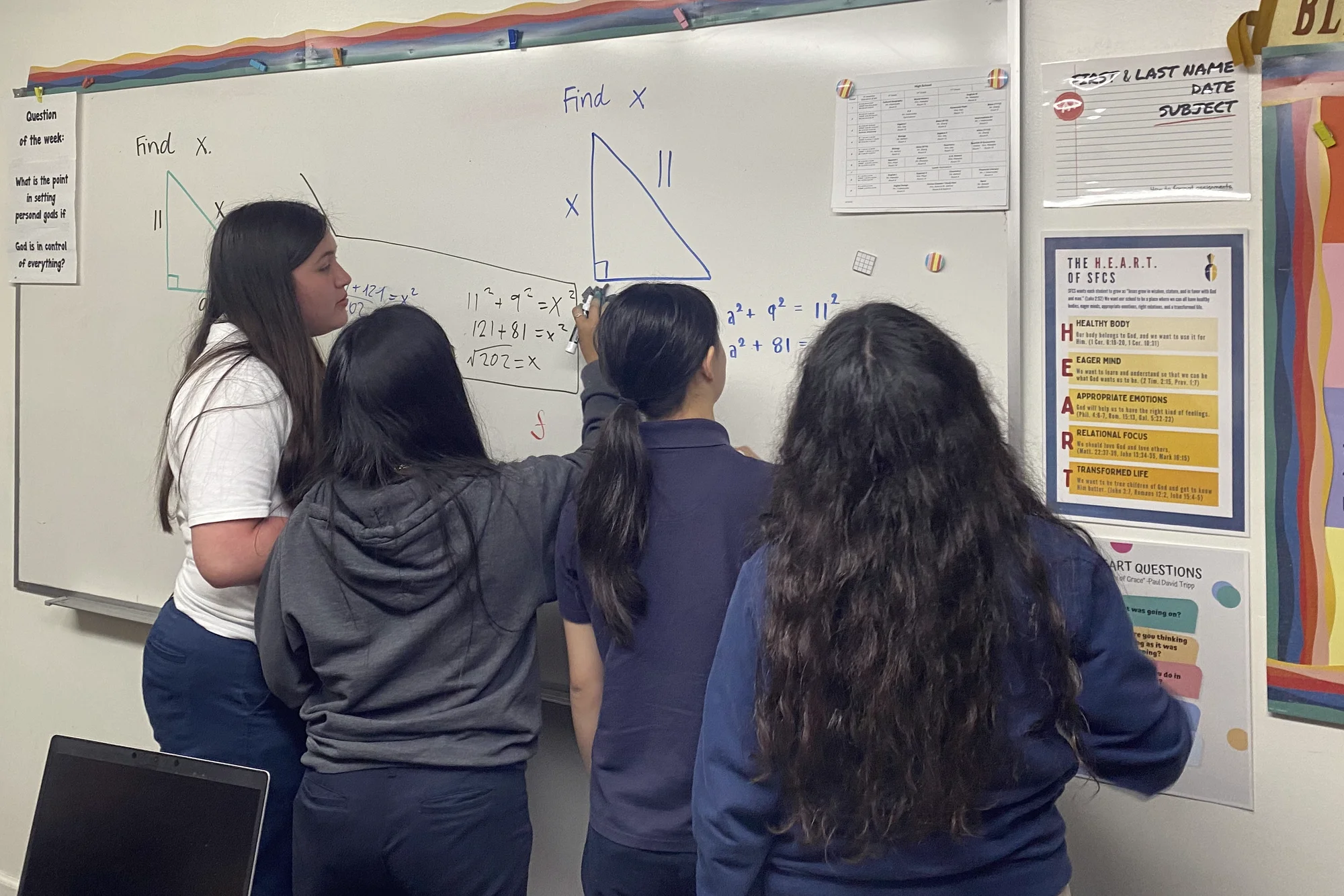 Students working right-triangle problems together at the classroom whiteboard